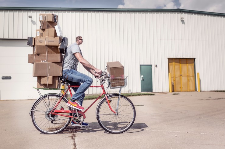 Bicycler with tiny head and many boxes