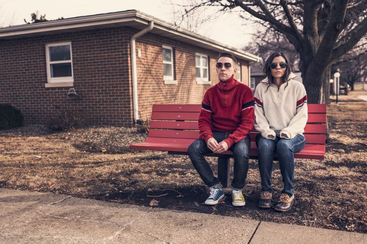 Woman & man waiting at bus bench