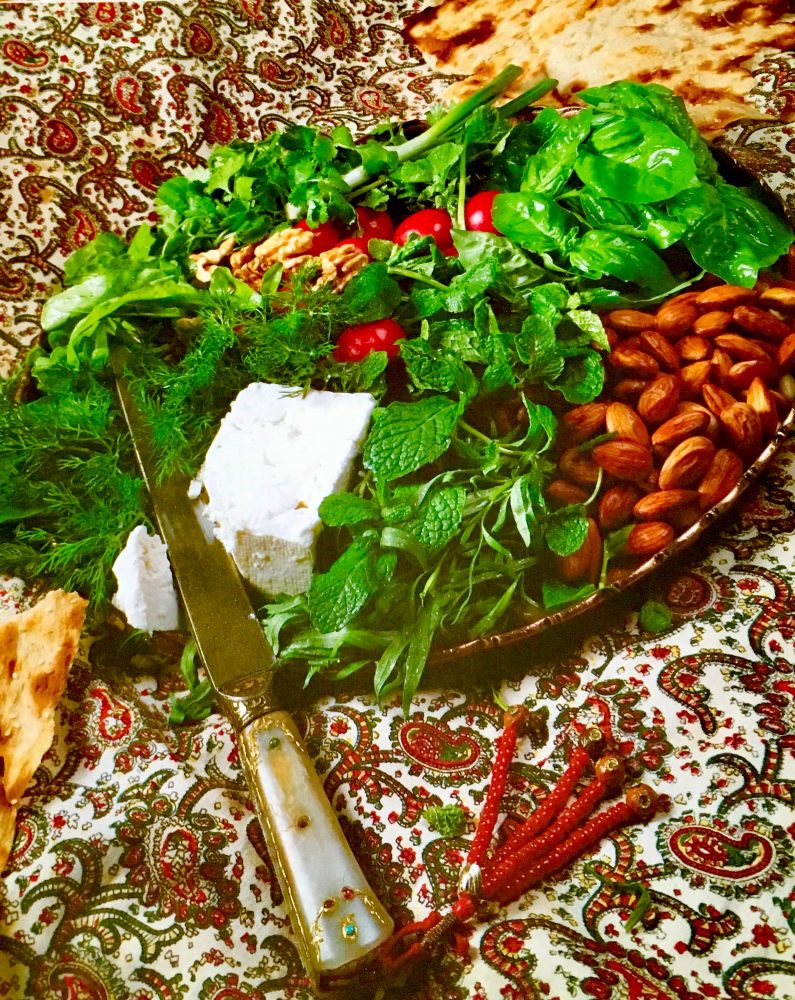 Platter of fresh herbs, feta, and nuts