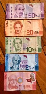 Paper currency is super colorful and bills come in different sizes.