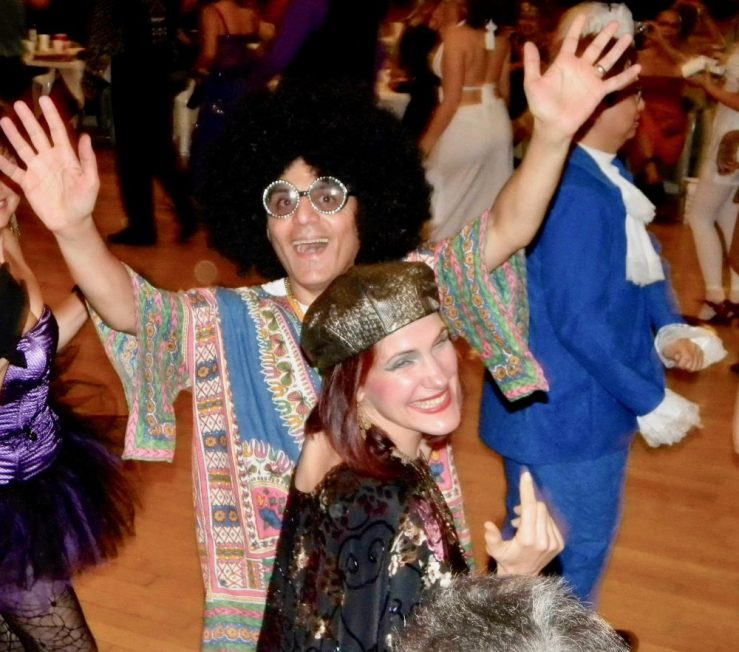 da-AL and her husband in Halloween 1970s disco costumes.