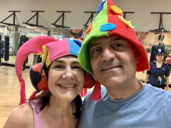 Photo of da-AL and Khashayar wearing funny hats at the gym where they take Zumba classes.
