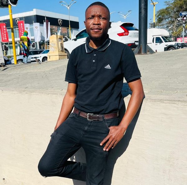 Photo of Letlhogonolo Peter standing in front of a shopping mall in South Africa (Melrose) while he was on vacation.