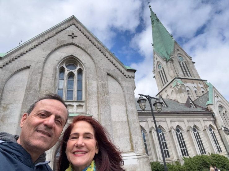 Khashayar and da-AL in front of a historic church in Kristiansand, Norway.