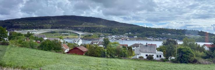Photo of bridge over waterway along pastures and small towns.