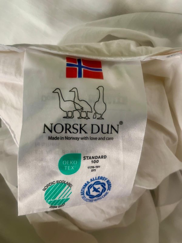 Photo of a label on a bedsheet, showing that it was woven in Norway.
