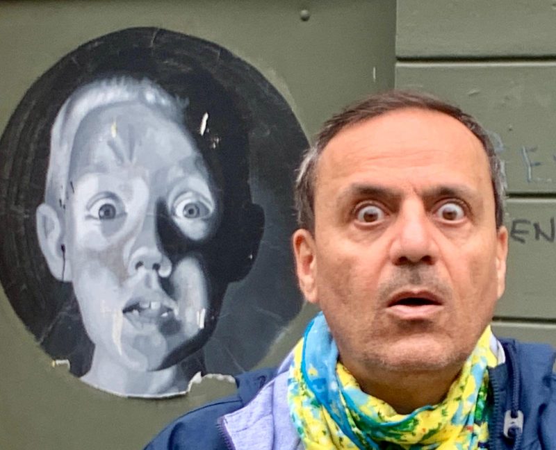 Khashayar assumes the same shocked expression of a mural of a shocked young boy in Bergen, Norway.