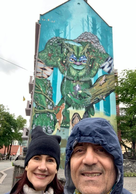 da-AL and Khashayar in front of a mural of a giant troll, Bergen, Norway.