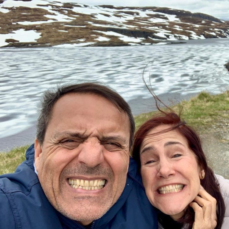 Photo of Khashayar and da-AL, teeth chattering with cold, at Snow Road in Vik, Norway.
