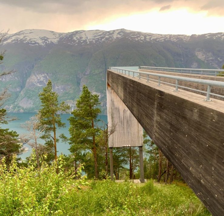 Photo of Stegastein Viewpoint extending like a huge inverted "L" shape past the mountain near Vik, Norway.